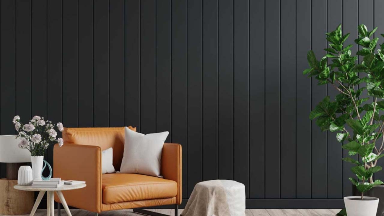 Living room interior wall mockup in dark tones with leather armchair on black wooden wall background.3d rendering