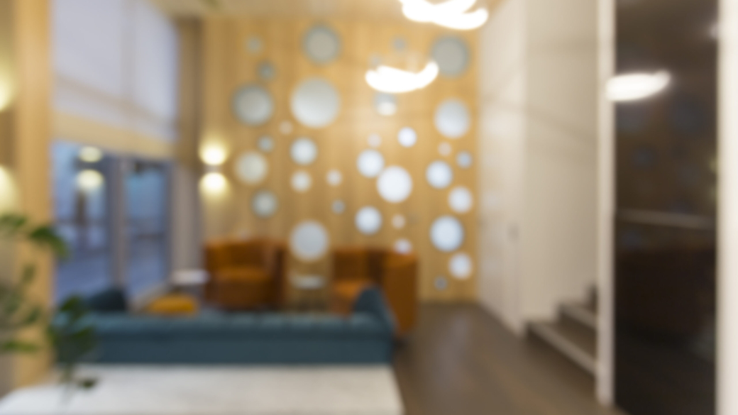 Blurred photo of waiting area for children with parents in empty dentistry, interior with no people, copy space